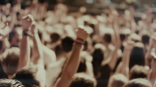 Iconic rock concert front row crowd cheering hands in air slomo crane pan 100p
