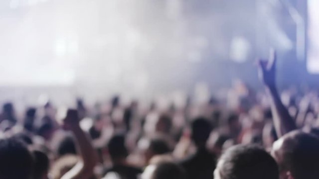Iconic rock concert front row crowd cheering hands in air slomo crane pan 100p