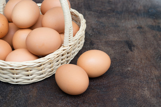 Chicken Egg in a basket on wooden table