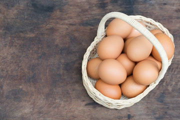 Chicken Egg in a basket on wooden table