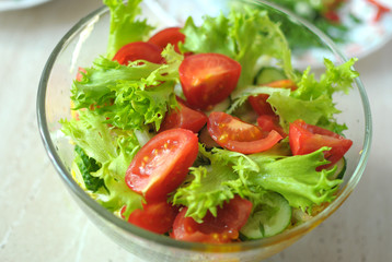 fresh vegetable salad with tomato, cucumber and salad frisee