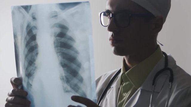 The doctor is studying an X-ray. A medical worker makes a bad diagnosis