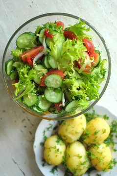 fresh vegetable salad with tomato, cucumber and salad frisee