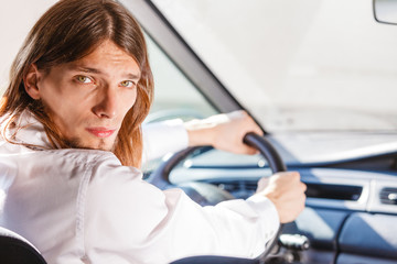 Man in car looking at back seat