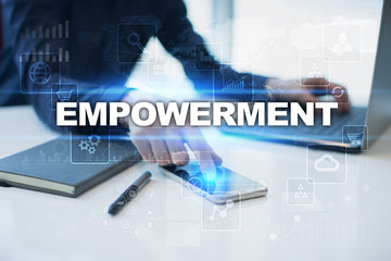 Businessman working in office, pressing button on virtual screen and selecting empowerment.