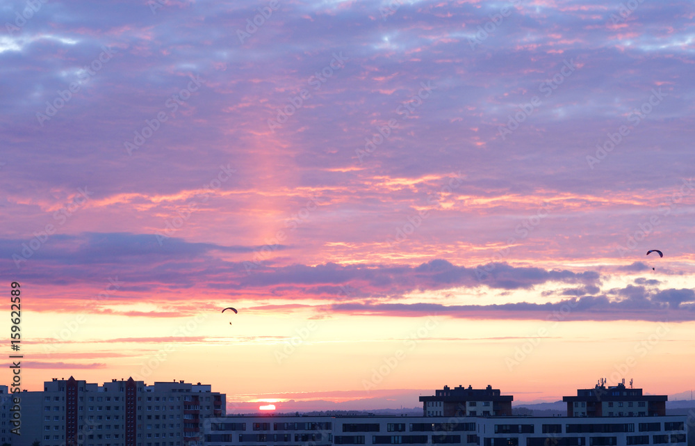 Wall mural Beautiful sunset and paragliders in the sky