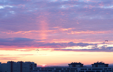 Beautiful sunset and paragliders in the sky