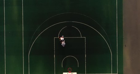 Basketball. Young girl trains basketball on street basketball court - Powered by Adobe