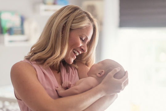 Mother holding baby son (0-1 months)