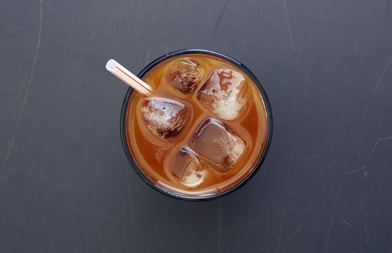 Overhead view of iced coffee with drinking straw