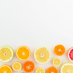 Sliced tasty citrus on white background. Flat lay, top view