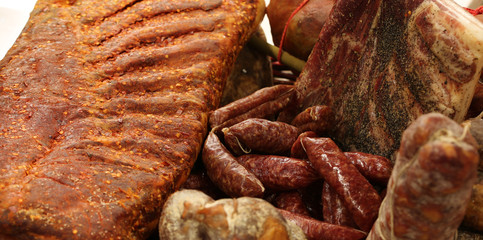 salamis for sale in the stand of local produce in southern Italy