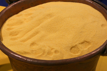 Yellow flour in old copper cauldron