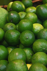 Fresh green limes on retail market close up
