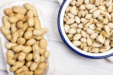 From above peanuts and  pistachios  on wooden background.