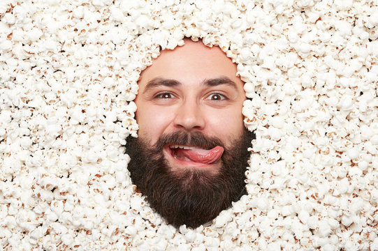 Man with tongue out in popcorn