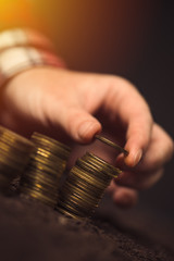 Farmer stacking coins, agricultural income