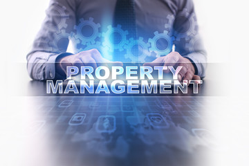 Businessman working with modern tablet pc and selecting property management.