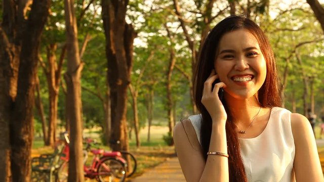 Thai pretty woman talkative with smartphone