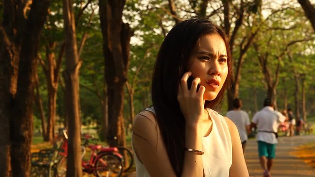 Thai pretty woman talkative with smartphone