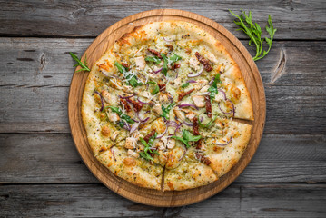 pizza with sun-dried tomatoes, prosciutto, arugula and parmesan cheese