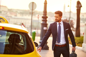 Young businessman with a taxi