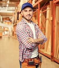 Carpenter with tool belt at storehouse