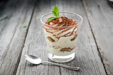 Traditional Italian dessert tiramisu in a glass.