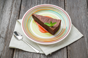 Delicious chocolate cake on plate on table