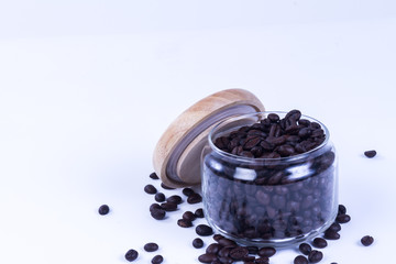 Fototapeta na wymiar Coffee beans in the jar on dark wood background