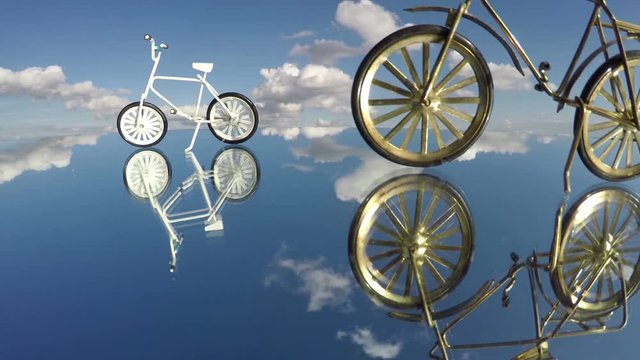 Small bicycle model toys on mirror and sky clouds motion, time lapse 4K