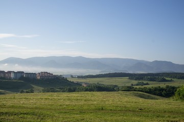 Fototapeta premium Sunrise and sunset over the hills and town. Slovakia