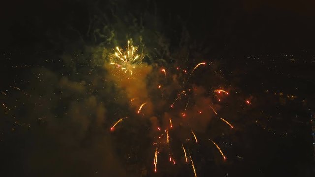 Aerial view Beautiful fireworks video from the drone in the night sky on celebration. Sparks. Fireworks are a class of explosive pyrotechnic devices used for aesthetic and entertainment purposes