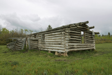 Abandoned and delapidated log cabin in rural setting