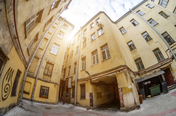 Closed yard old houses wells in St. Petersburg sky and light.