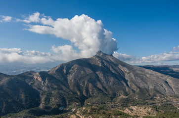 Clouds over top of Sierra de Bernia mountains range, near Benidorm, Spain