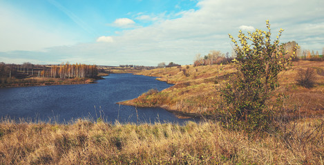 Sunny autumn landscape with river