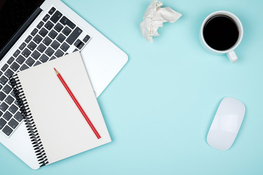 Minimal workplace with laptop and blank notepad