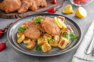 Schnitzel original with lemon and gnocchi fried