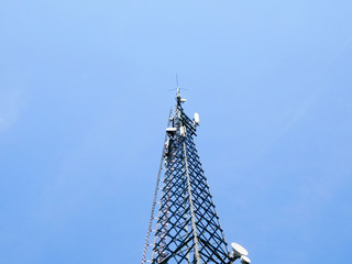 communication tower in front of blue sky