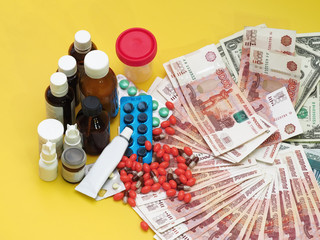 Obraz na płótnie Canvas Collage. Medications are close to cash. Yellow background.