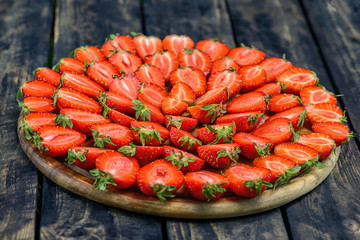 Strawberries on a plate on a wooden table