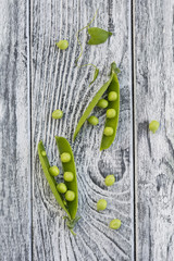 Green peas on grey wooden background