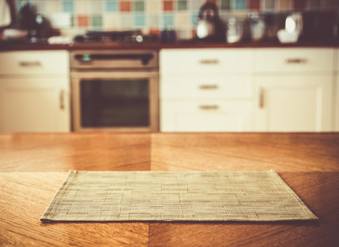 Blurred Kitchen Interior And Napkin And Desk Space