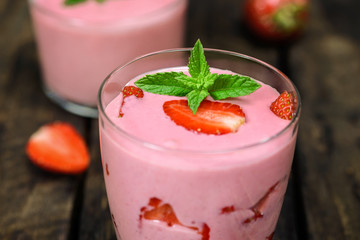 Strawberry smoothie on a wooden background