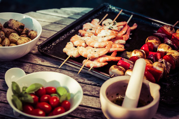 barbecue in the garden - summer- prawns and vegetables on skewers