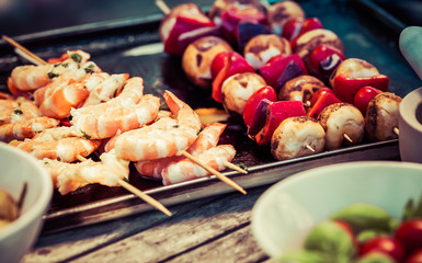 barbecue in the garden - summer- prawns and vegetables on skewers