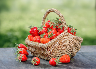 Fototapeta na wymiar Strawberries in a basket on a wooden table