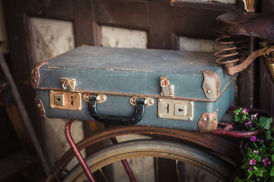 Old vintage suitcase and bicycle