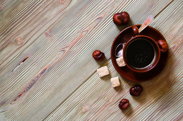 Brown cup of coffee on a wooden table